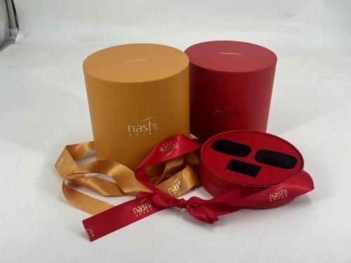 OEM and ODM Round Gift Box with Silk Ribbon Cosmetic Products Boxes with Gold Stamping and EVA liner For Sale